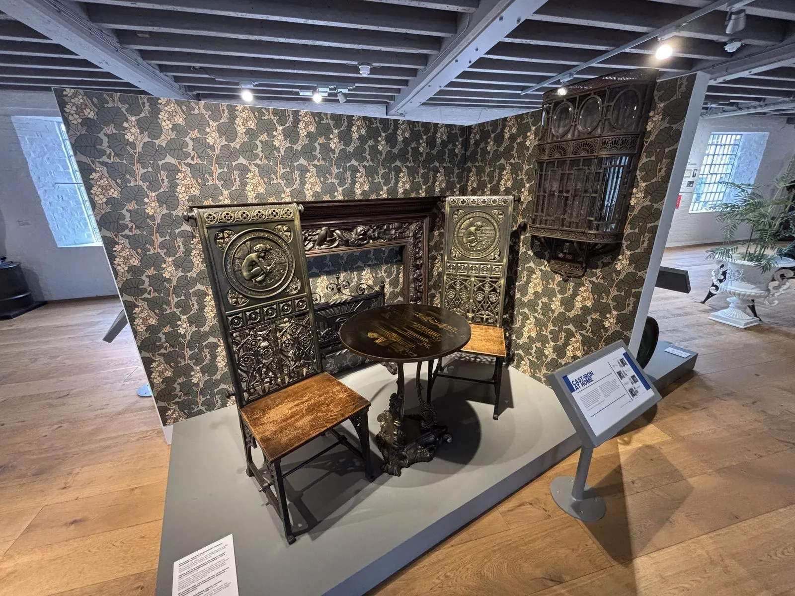A Victorian parlour corner at the Museum of Iron: chairs, a table, a fireplace and a wall bracket, all made of cast iron